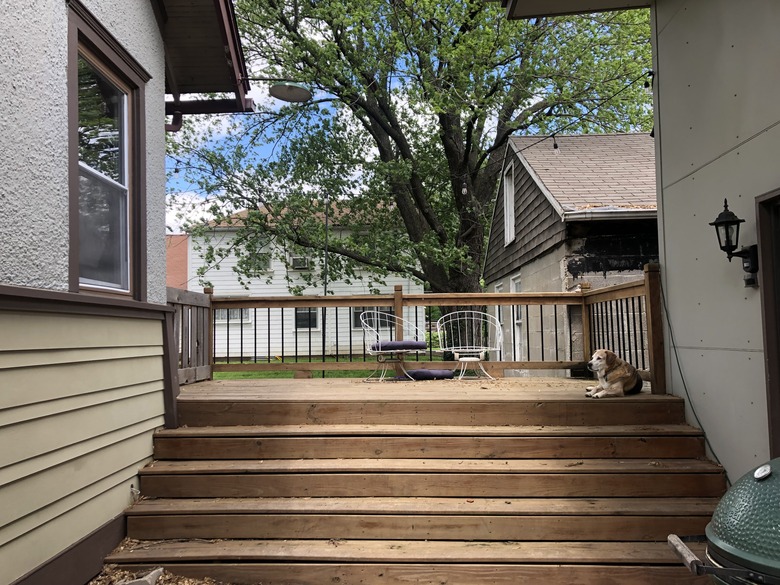 Back deck before and after with a slatted screen fence and wicker furniture