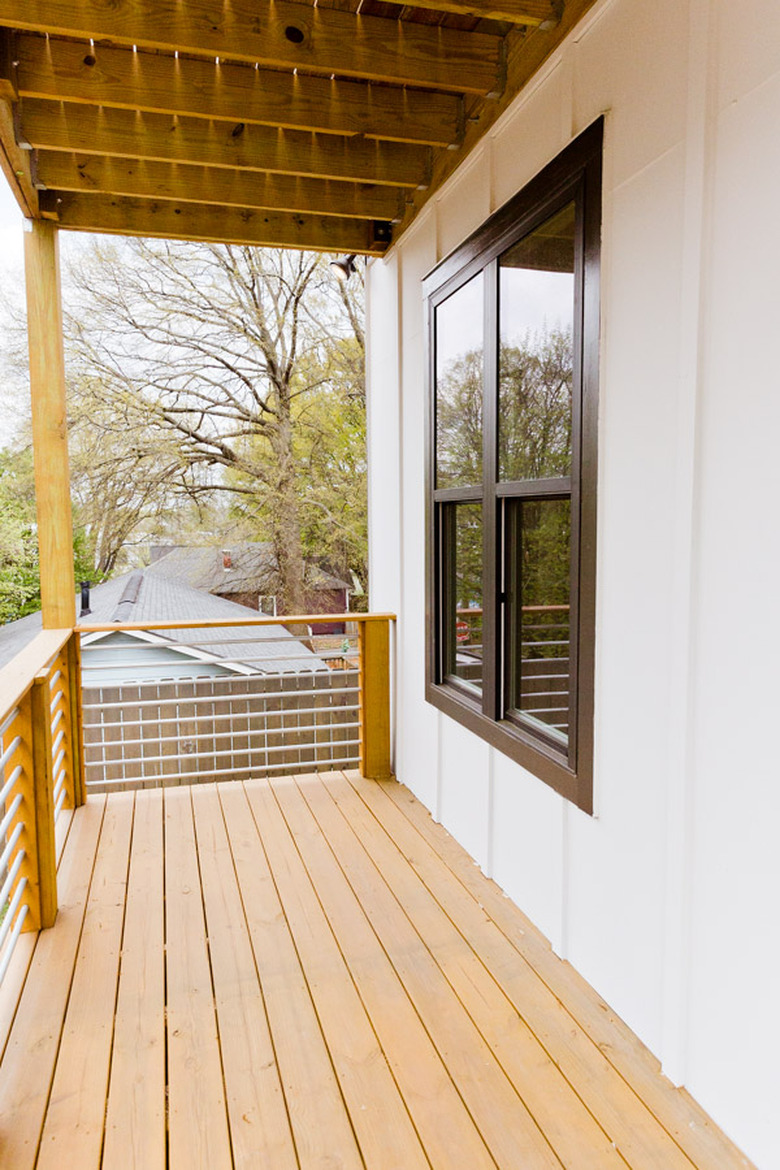 Front porch before and after with blue rocking chairs and plants