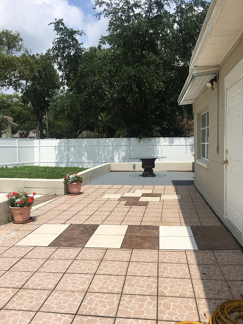 Patio before and after with a stenciled concerete floor and string lights