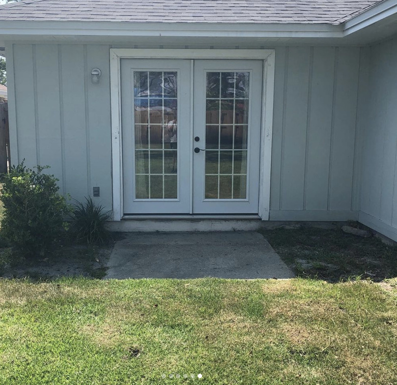 A small back patio before and after with a painted floor and red chairs