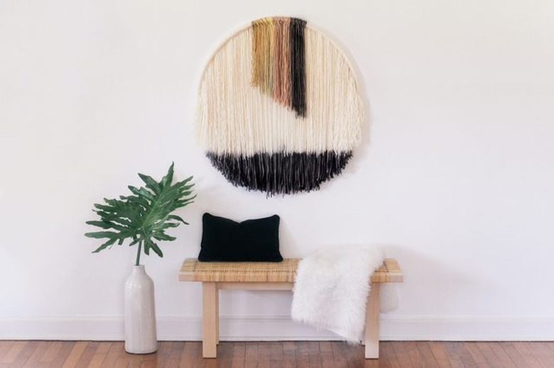 Dip-dye wall art hangs above an entryway bench