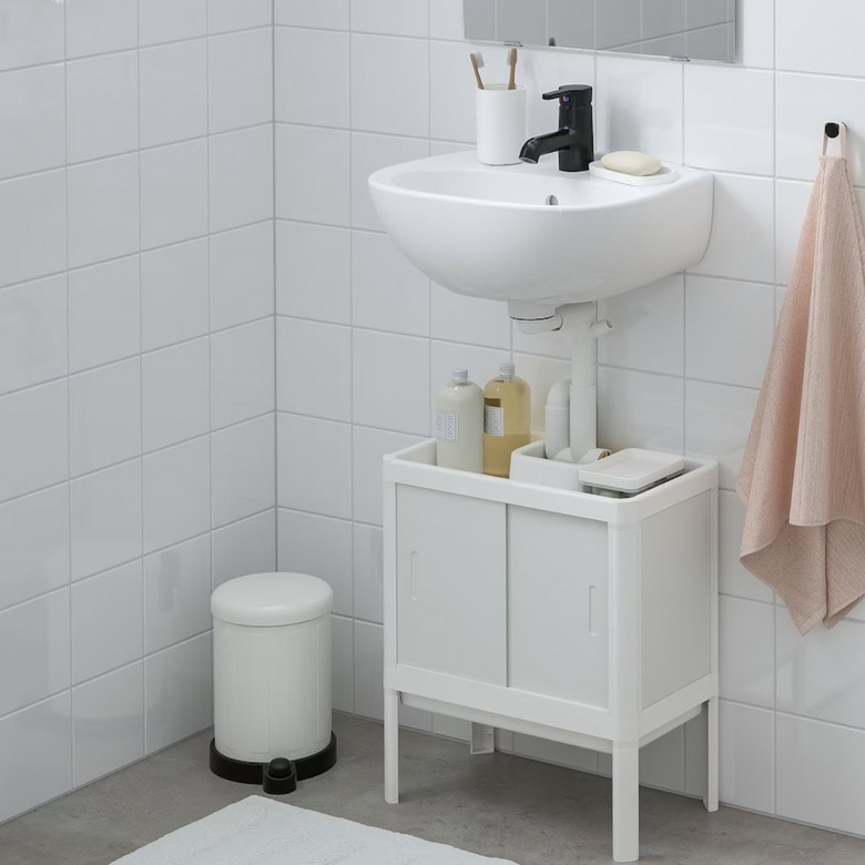 minimal white IKEA bathroom vanity with black faucet
