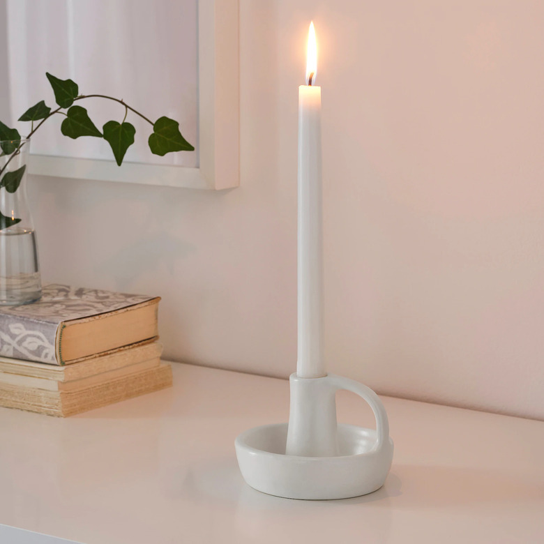 white candlestick on candle holder