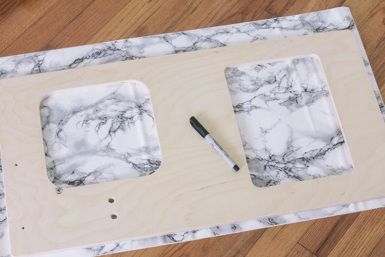 Tracing sink and stove shapes on contact paper