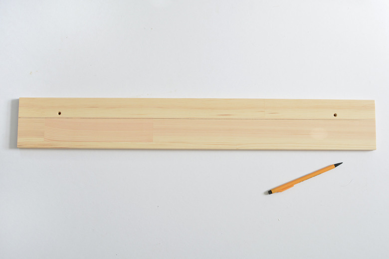 Wooden shelf with cut line drawn in pencil