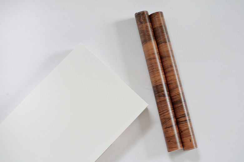 white ikea shelf and roll of walnut contact paper