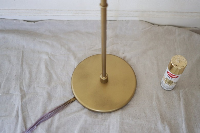 Spray painting base of lamp gold