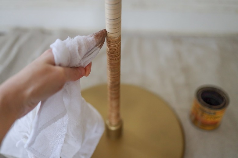 Wiping Golden Oak wood stain onto reed with a cloth