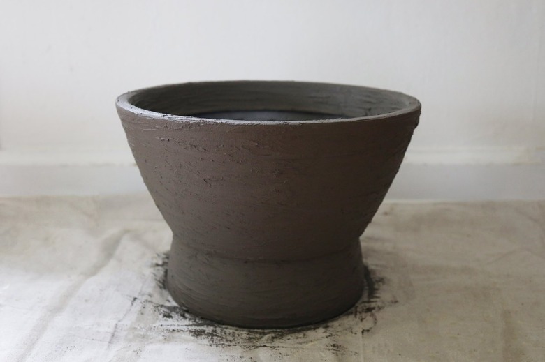 Planter covered entire in feather finish concrete mixture