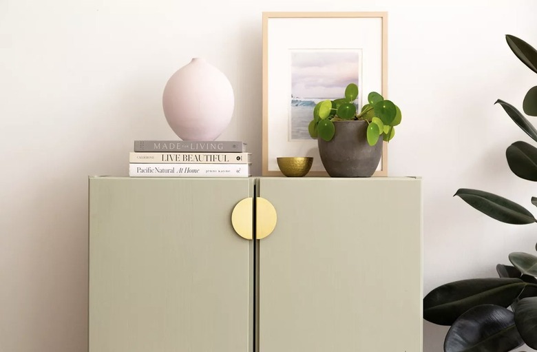 IKEA cabinet painted green with brass handles