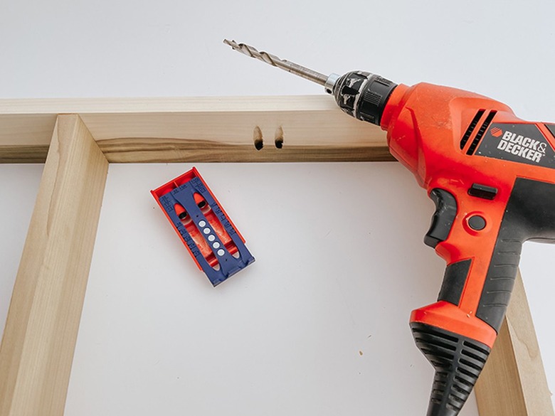 Drill down into the jig to create pocket holes for screws.