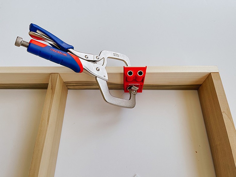 Clamp the pocket hole jig to the wooden base.