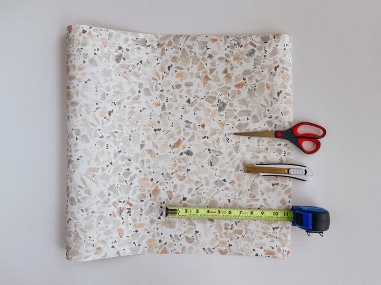 Measure and mark the wallpaper.