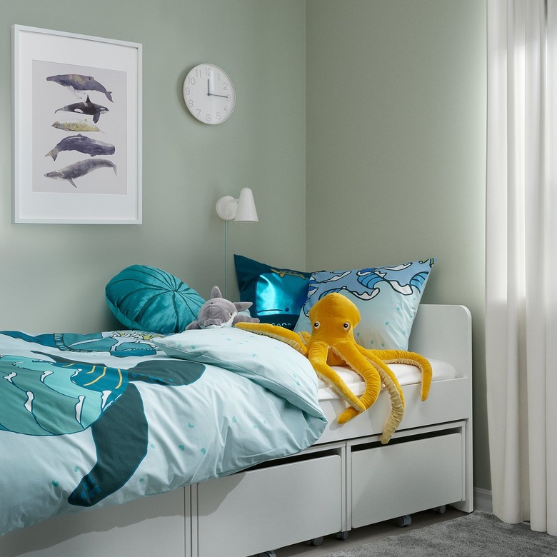 A children's bedroom with a white bed frame