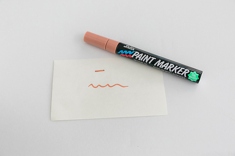 Practice using your paint marker on scrap paper.
