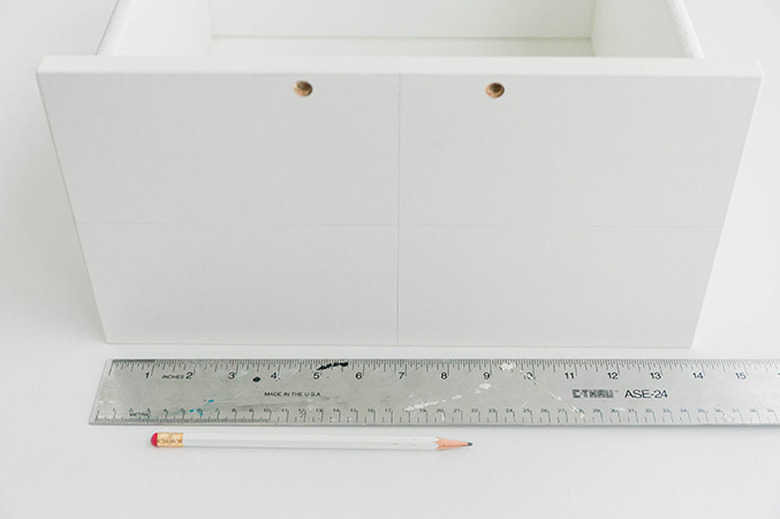 Draw a horizontal line down the center of the drawer front.