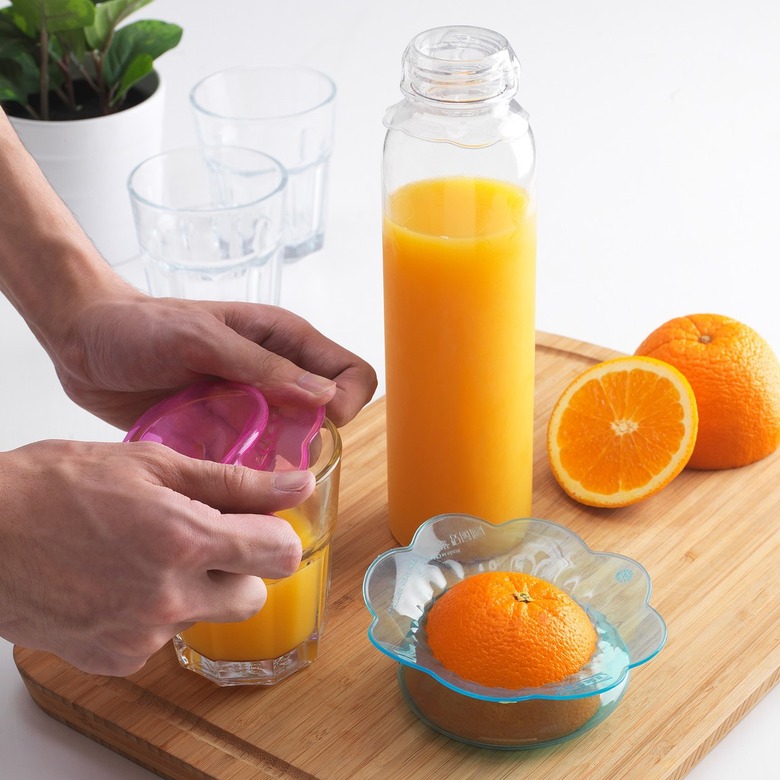 person with cover and orange juice nearby