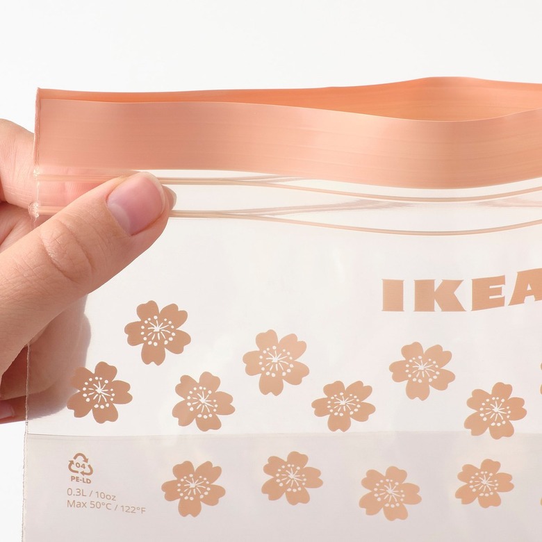 hand holding resealable peach-colored bag