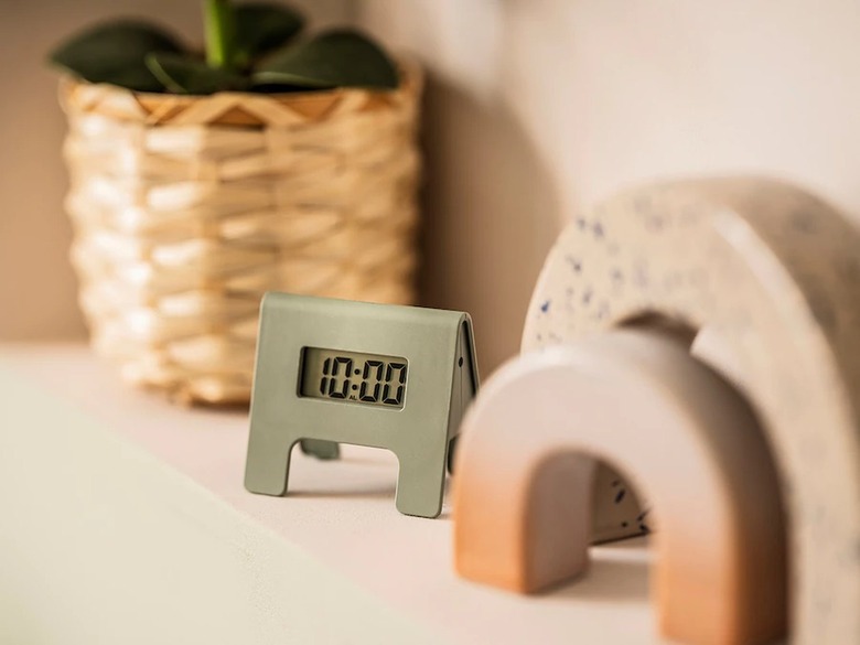 shelf with small alarm clock and decorative arches