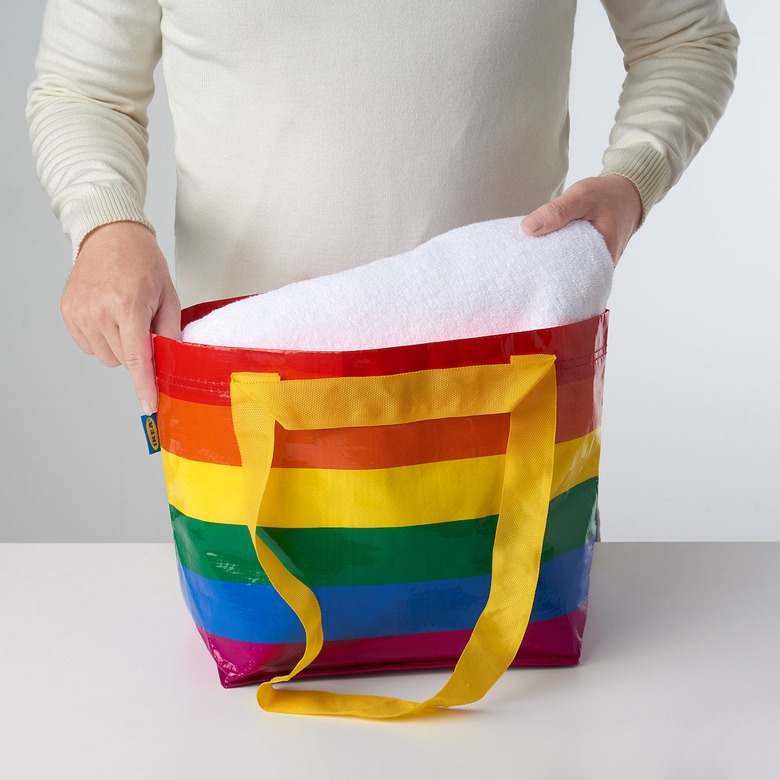person taking linen out of rainbow bag