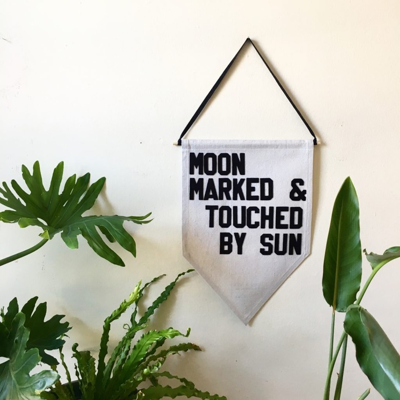 pennant with phrase moon marked and touched by sun