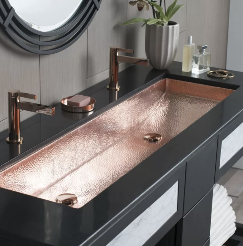 copper industrial bathroom sink with black vanity
