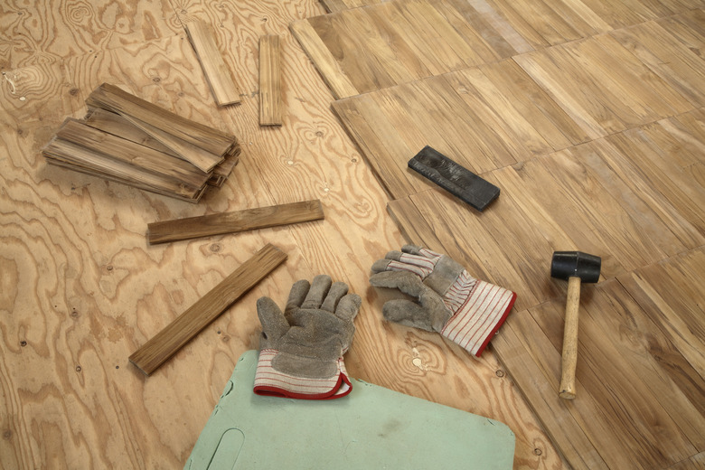 Laying wooden parquet flooring.