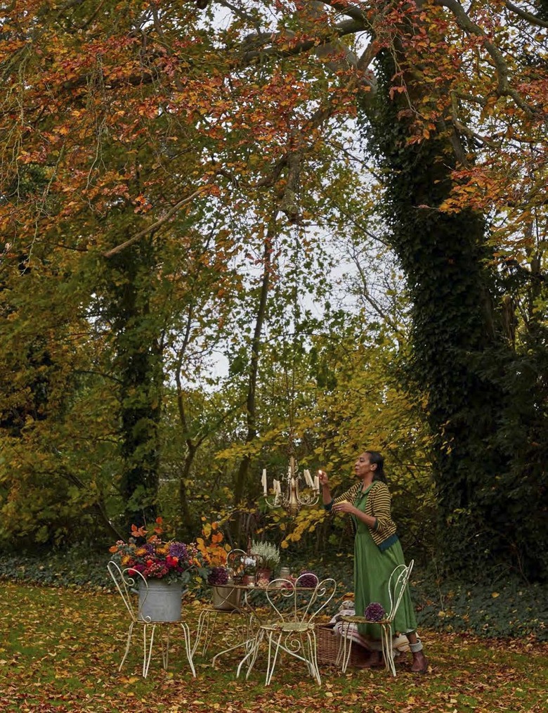 paula sutton outside at hill house decorating fall table