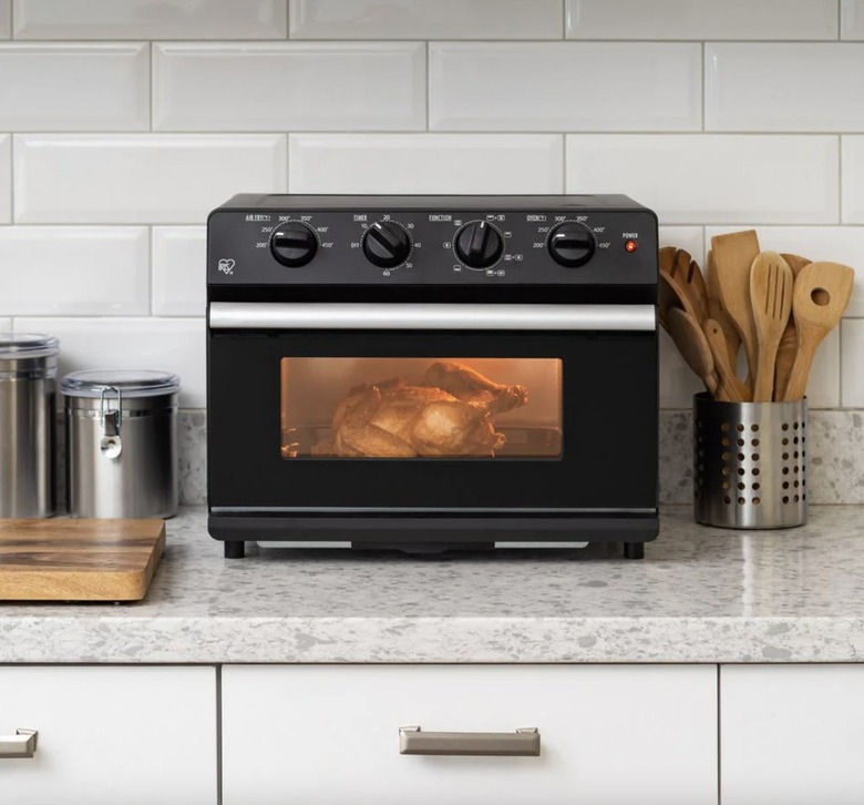 Air fryer with whole chicken inside