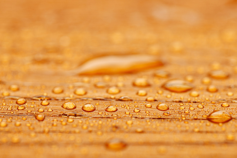 Protected wood after rain - covered with water drops