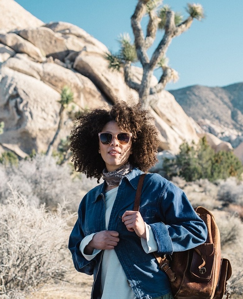 person in desert with backpack