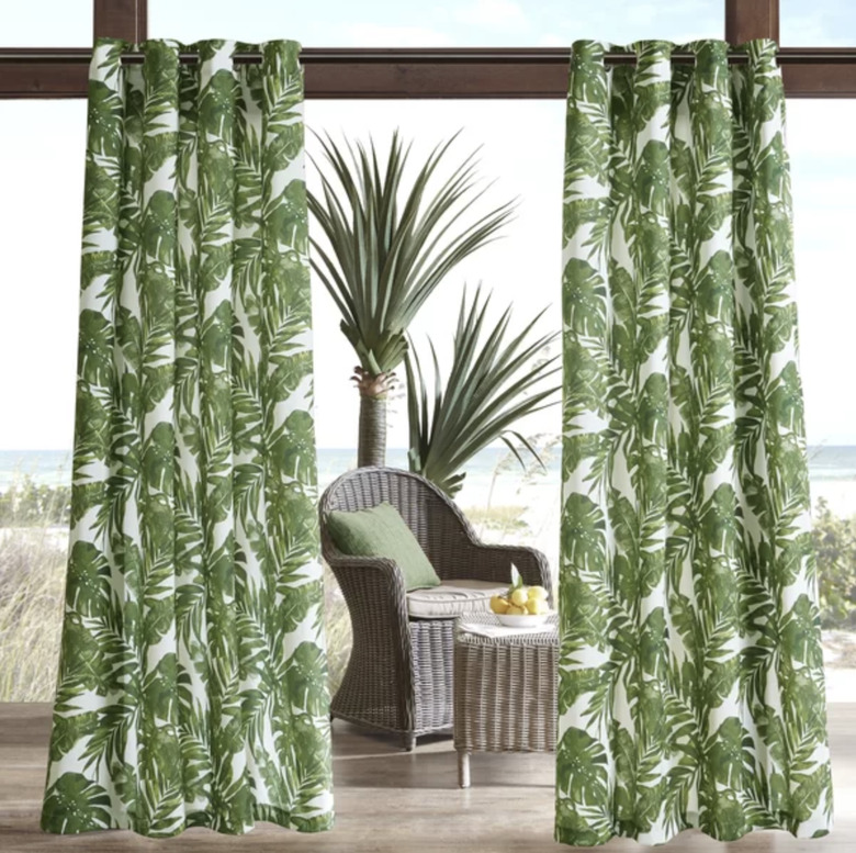 Palm leaf colored curtains in an outdoor beach setting
