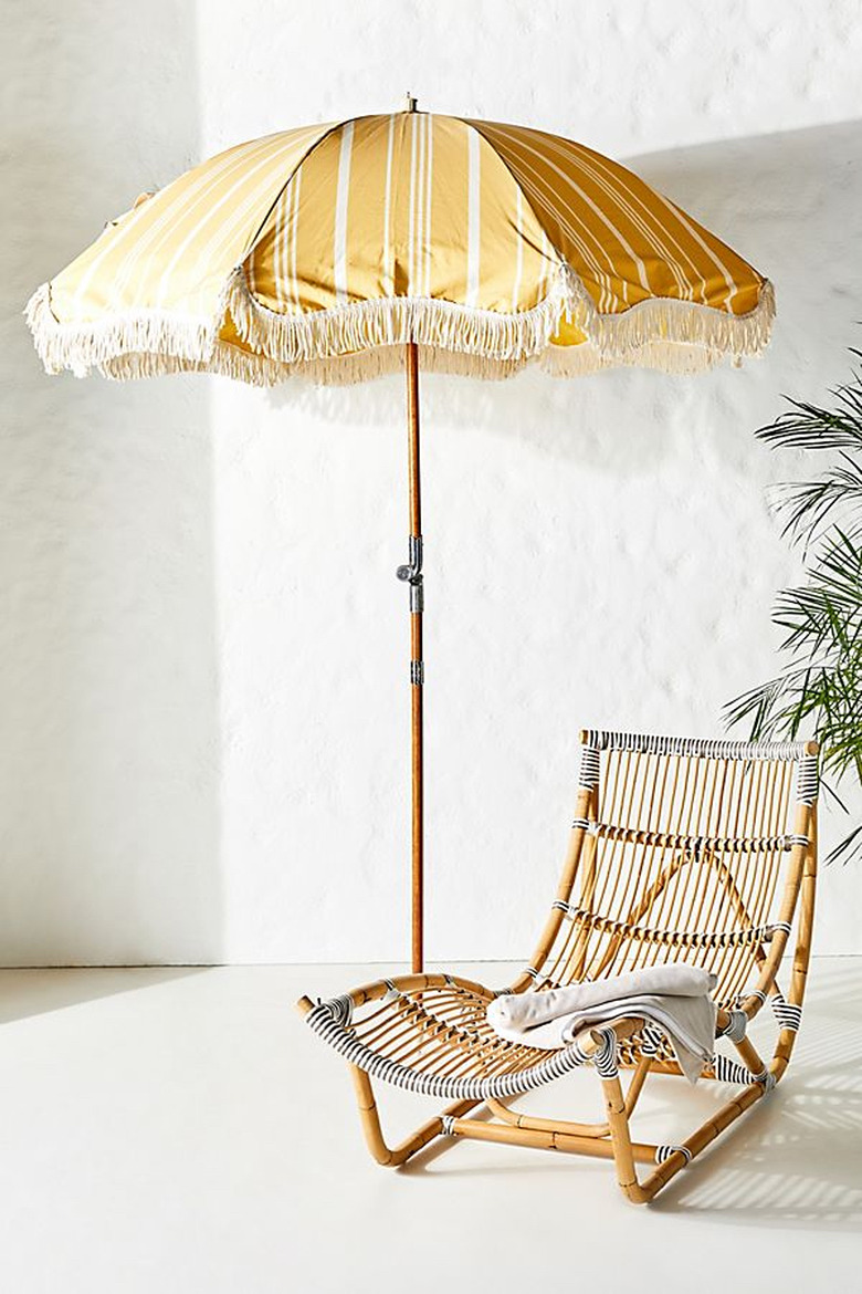 yellow beach umbrella with fringe tassel and stripes