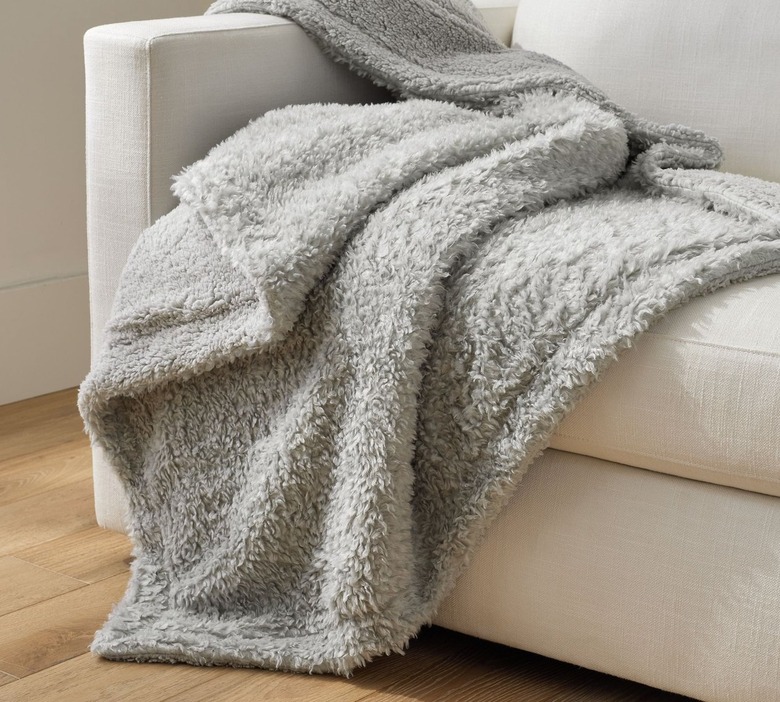 gray fuzzy blanket on couch