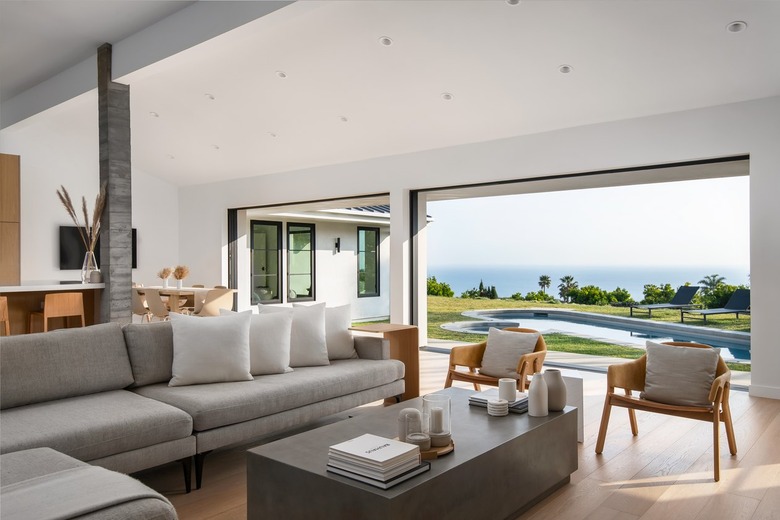 A Malibu living room with a couch and two wood chairs