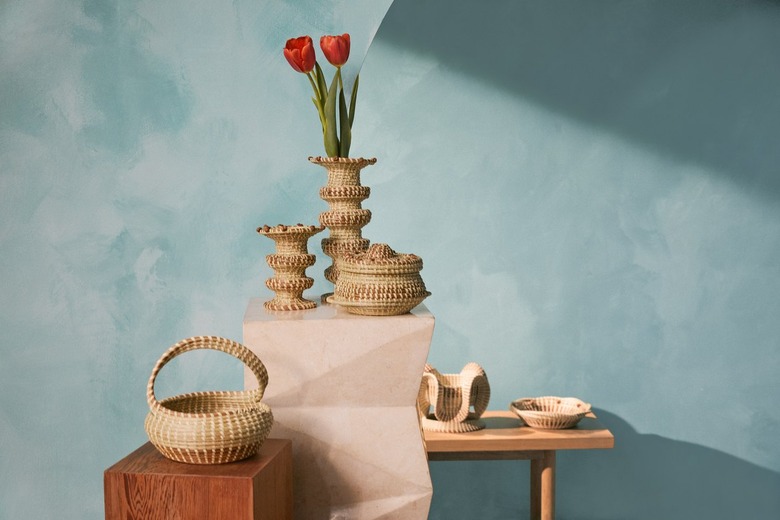 An assortment of decorative baskets on display in front of a blue wall