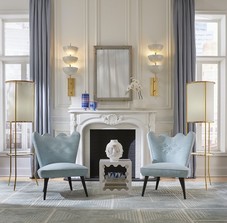 Jonathan Adler wavy accent table in a room with two light blue chairs