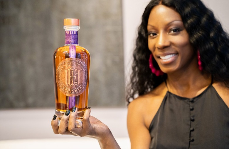 Nicole Young holding frisky whiskey bottle
