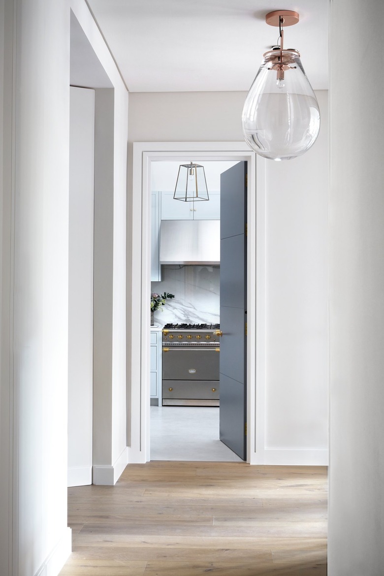 hallway with light fixture leading to kitchen