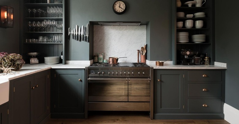 Kitchen with dark green cabinets and white counters