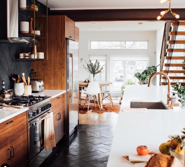 Dark wood cabinets with black tile backsplash