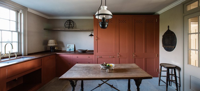 peach kitchen cabinets with gray flooring