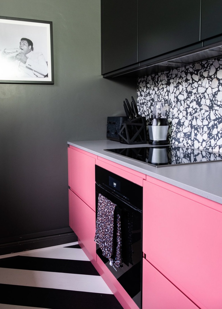 Kitchen with hot pink and black cabinets