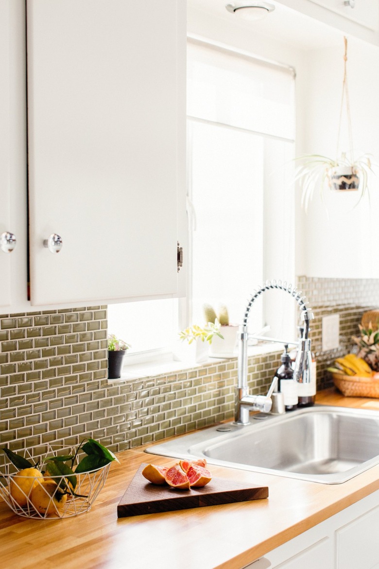 White cabinets with brown backsplash
