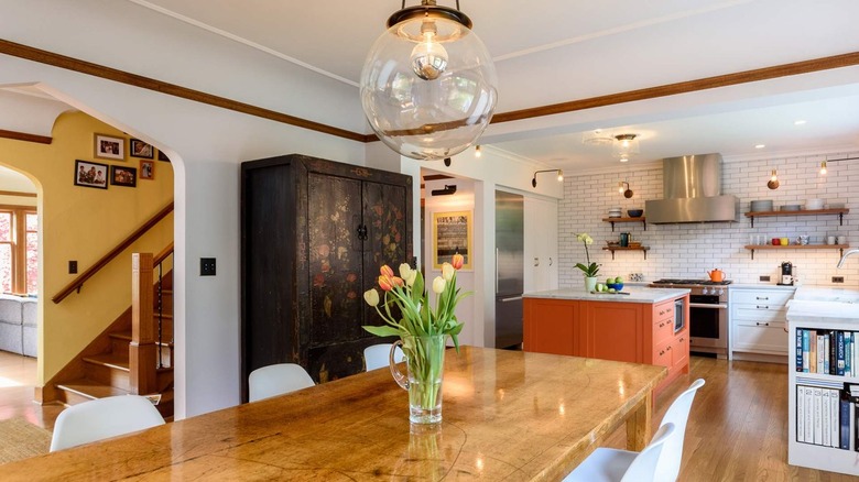 White and wood kitchen with warm orange island