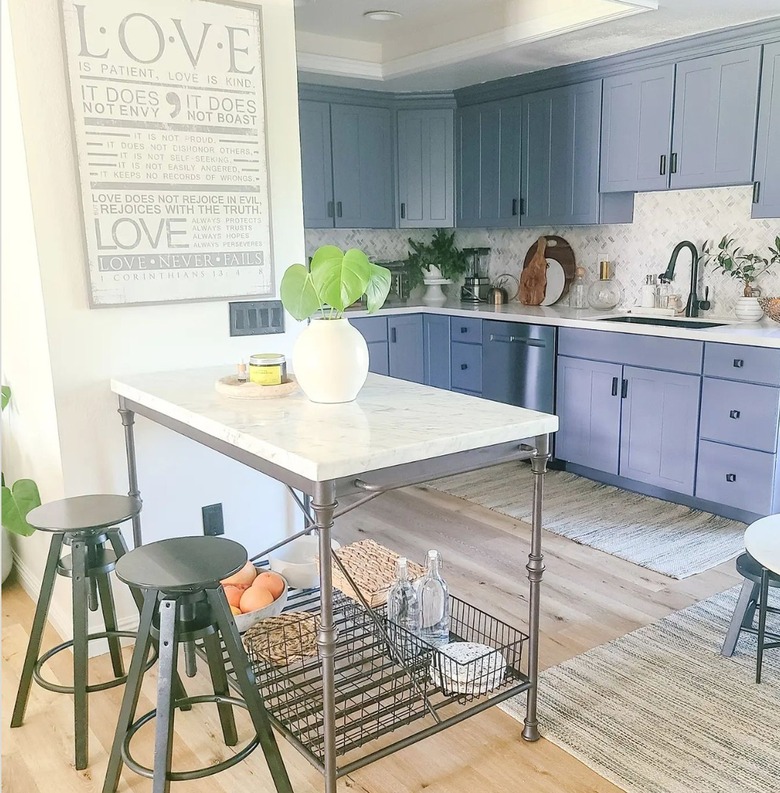 blue kitchen cabinets with marble top island