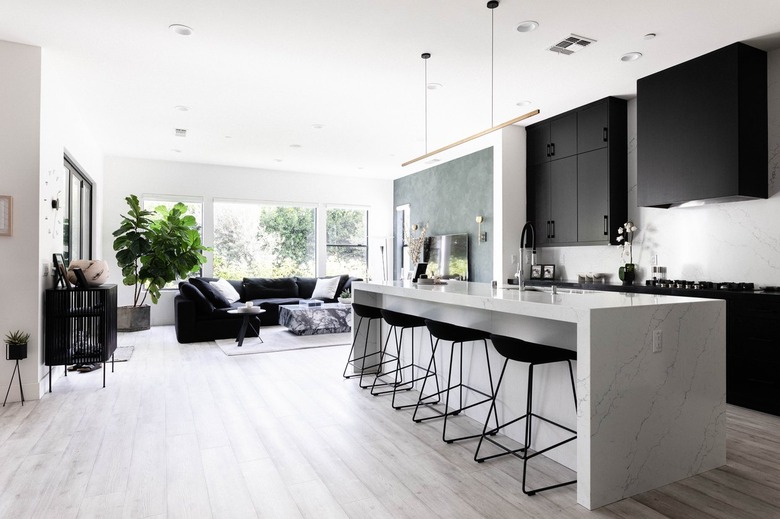 A modern kitchen with gray wood floors