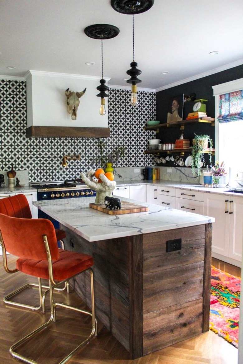 black geometric pendant lights in vintage kitchen above wood island