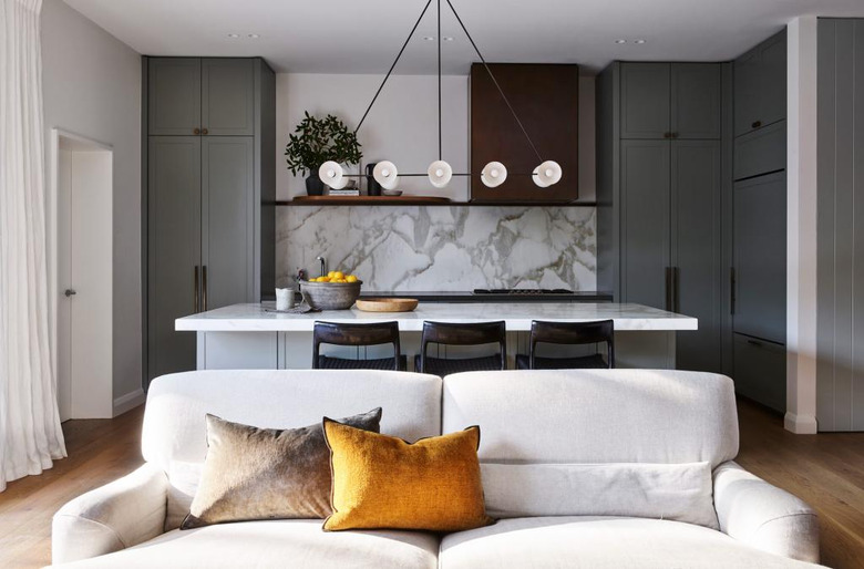 kitchen island lighting idea with ten light chandelier and marble backsplash