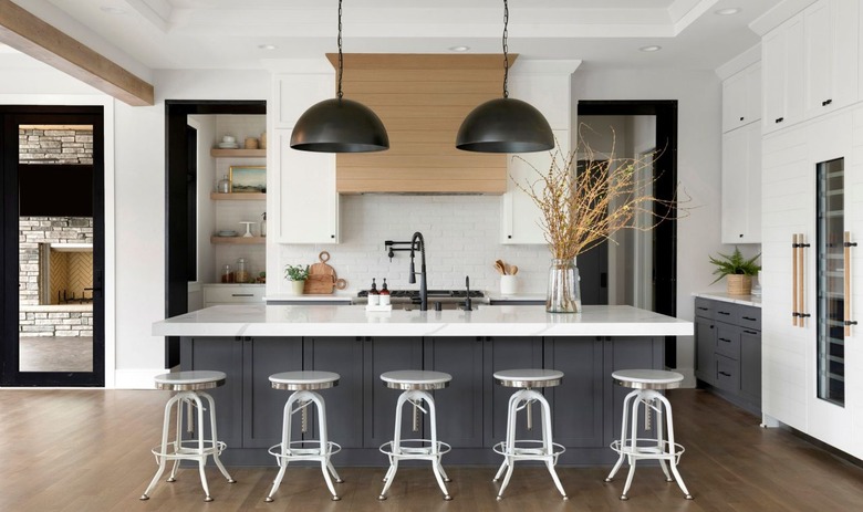large black bell style pendant lights above island